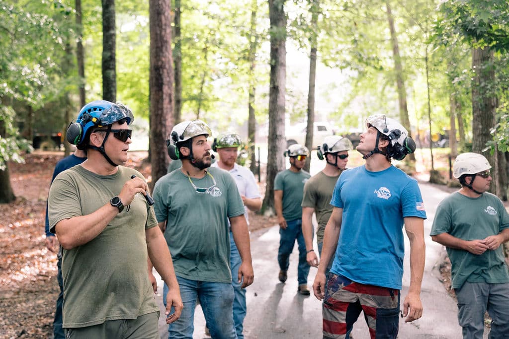 Miller's crew during a job-site briefing on a Thomas County property